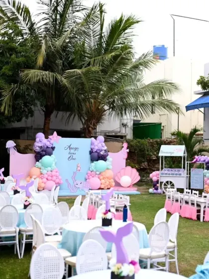 A duplicate wide shot of the outdoor sea-themed party, capturing the full scope of the decor and seating arrangement.