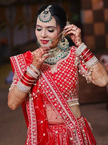 This shot showcases the detailed eye makeup and how it complements the bride's traditional nath.
