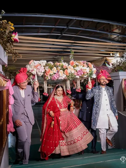 The bride's entry down the stairs, led by her brothers under a beautiful 'phoolon ki chadar'.