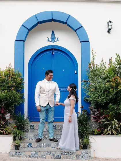 A wider shot of the couple in front of the beautiful blue door, showcasing the lovely location of their engagement shoot. I am always ready to travel to special places for your photos.