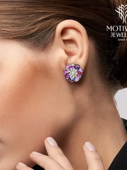 A pair of colorful floral stud earrings, featuring a mix of purple and pink gemstones. These are perfect for adding a pop of vibrant color and personality.