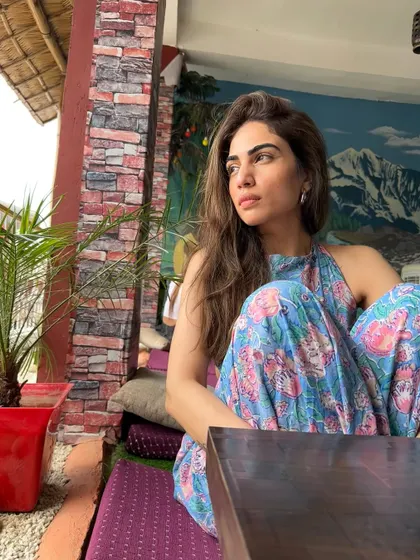 A relaxed moment in my floral jumpsuit, taking in the views at a local cafe in Rishikesh.