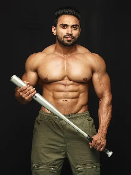 A straight-on shot showing the abdominal definition and chest fullness that my programs build.