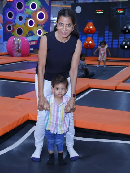 A wonderful moment between a guardian and a toddler taking his first gentle bounces on the trampoline. We ensure a safe space for all age groups.