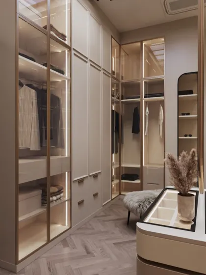 Another angle of the beige walk-in closet, showing the thoughtful layout that maximizes storage while maintaining an open and airy feel.