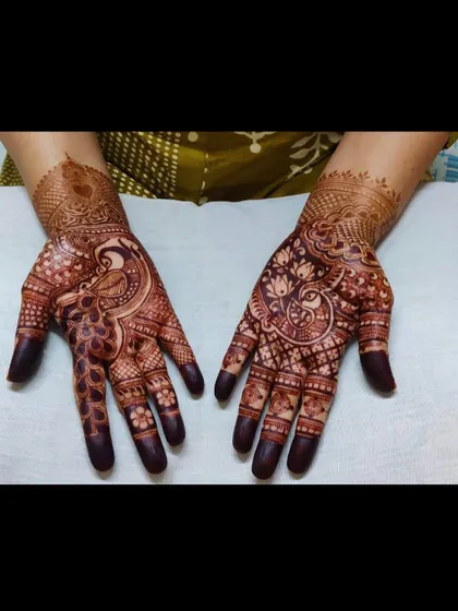 The beauty of a dark, mature henna stain. These hands showcase the rich color and intricate peacock designs a few days after application.