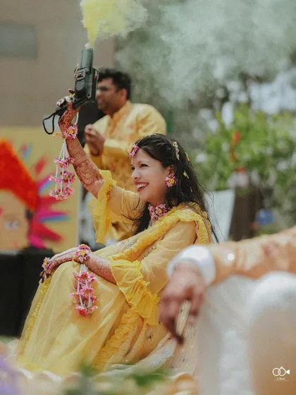 A duplicate of the bride with the smoke gun, a great shot showing the fun elements of the event.
