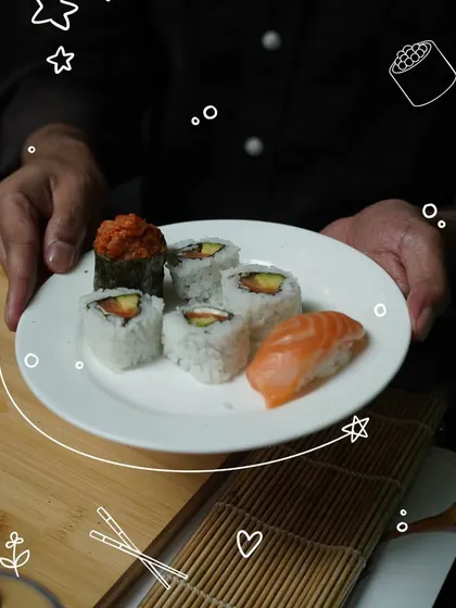 A plate of beautifully crafted sushi, including maki rolls and salmon nigiri, ready to be enjoyed. This is the delicious reward after learning the techniques of rolling and shaping.