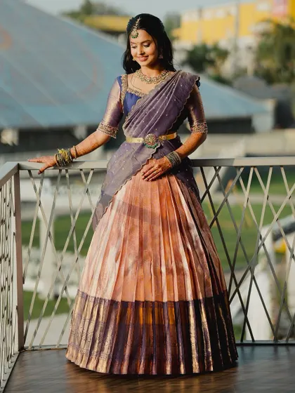A beautiful shot of Brunda on the balcony, her custom langa voni catching the light perfectly.
