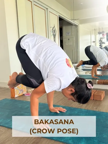 Bakasana (Crow Pose) is a fun and empowering arm balance. This image highlights the focus and strength required to take flight in this foundational pose.
