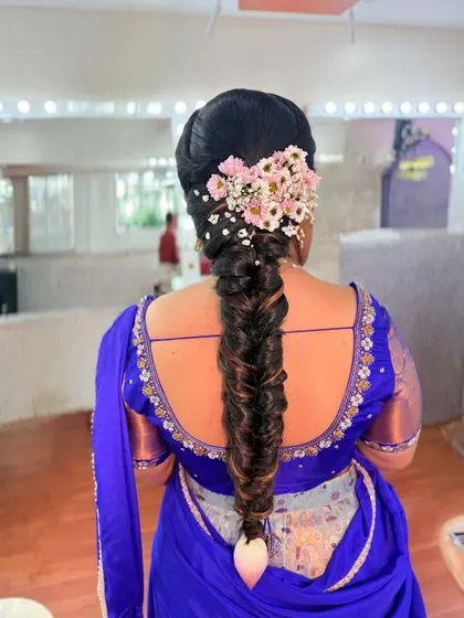 A beautiful fishtail braid adorned with fresh flowers for an engagement ceremony. This hairstyle is both modern and traditional, perfect for any special occasion.