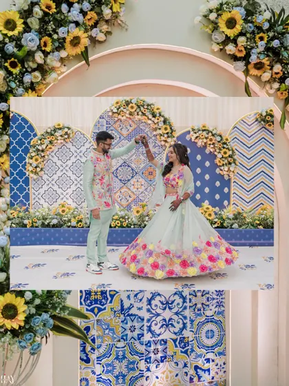 A creative shot of the couple dancing, framed by the intricate floral and tile-patterned Haldi decor.