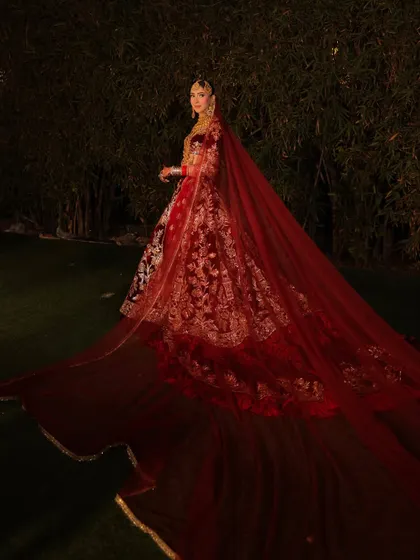 A reception look that is pure royalty. The drama of the long, flowing veil on this Manish Malhotra creation called for a makeup look that was equally grand. We focused on creating a sculpted, glamorous look that made her feel powerful and breathtaking for her evening celebration.