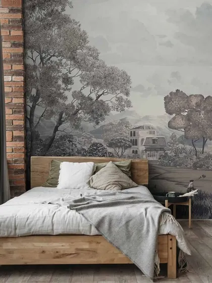 A grayscale landscape mural gives this rustic bedroom a serene, artistic feel. The design complements the natural wood bed frame and brick wall, creating a cohesive and calming environment.