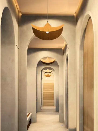 Looking down the arched corridor, the repetition of form and the unique, boat-shaped pendant lights create a strong sense of rhythm and perspective. This design guides movement and calms the mind.
