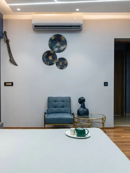 A quiet corner in the bedroom, featuring a comfortable armchair and curated wall art. Even the smallest details are chosen to contribute to the room's overall mood of bold tranquility.
