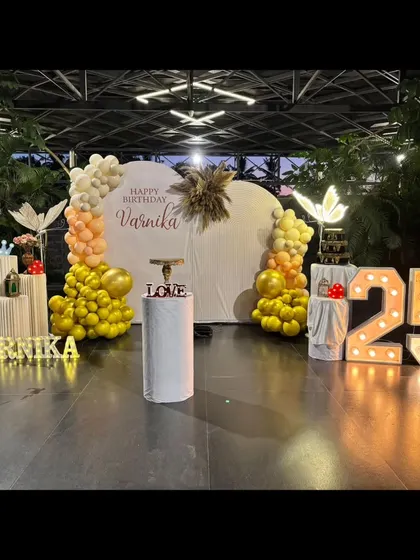 A beautiful and elegant butterfly-themed 25th birthday. The heart-shaped backdrop, warm yellow and white balloons, and glowing butterfly props create a magical and sophisticated ambiance.