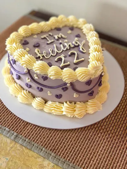 A side view of the heart cake, showing the detailed buttercream piping.