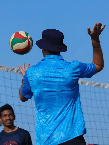 Tossing the ball to demonstrate the arc of a perfect set. I believe in showing, not just telling.