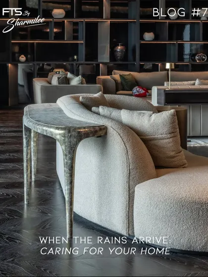 A close-up of a custom curved sofa paired with a sculptural, hammered metal console table. This pairing highlights our focus on combining unique forms and material textures to create furniture with a distinct personality.
