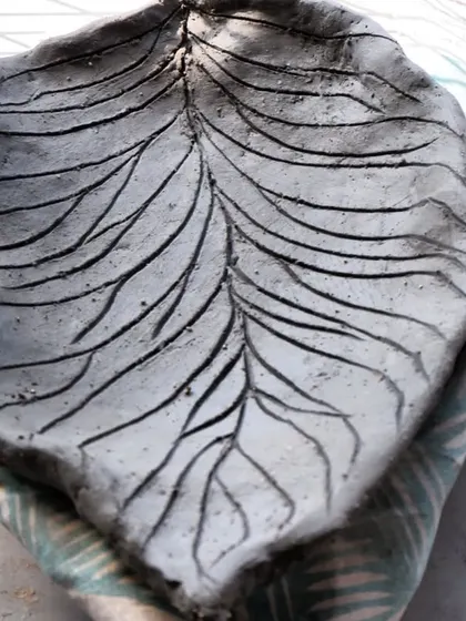 A leaf-shaped platter before Raku firing. The veins are carved into the raw clay. At this stage, you can only imagine the colors that the fire and smoke will create.