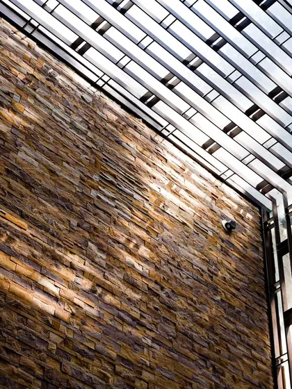 The play of light and shadow is a key part of our design. Here, sunlight streams through the skylight grill, creating a dynamic pattern that changes throughout the day.