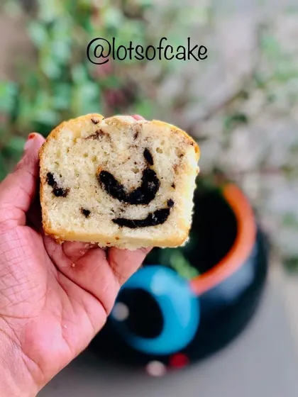 A slice of my marble cake held up to show the lovely chocolate swirls inside. It's the perfect hot tea cake for a rainy day.