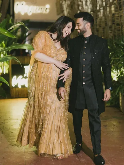 Juhi and Jay share a laugh during their engagement party. Dressed in stunning coordinated outfits, their happiness and connection are palpable in this walking shot.