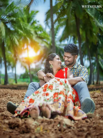 A relaxed and happy pre-wedding portrait in a field. This image captures the simple joy of being together in a natural, rustic setting.