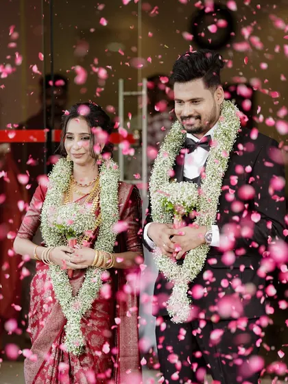A magical moment as the couple is showered with flower petals, their smiles shining through the celebration.