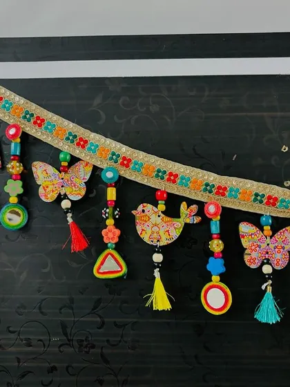 Another view of the 'Bageecha' Toran, showing the details from a different angle. I love the combination of my art with traditional elements like mirrors and bells.