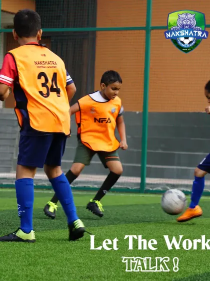 Let the work talk. A young player shields the ball, demonstrating the strength and determination honed during our training sessions.