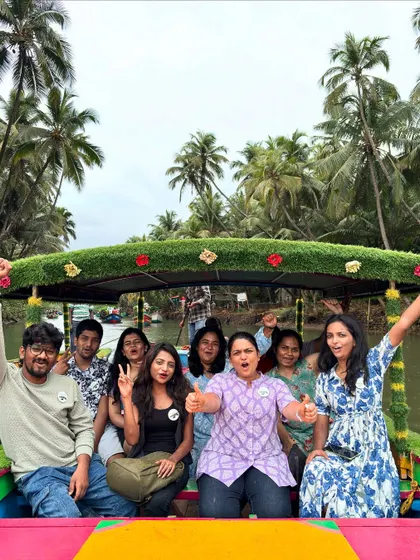 All smiles on a decorated boat in the Honnavar backwaters. The vibrant boat and happy faces capture the fun spirit of our trips.