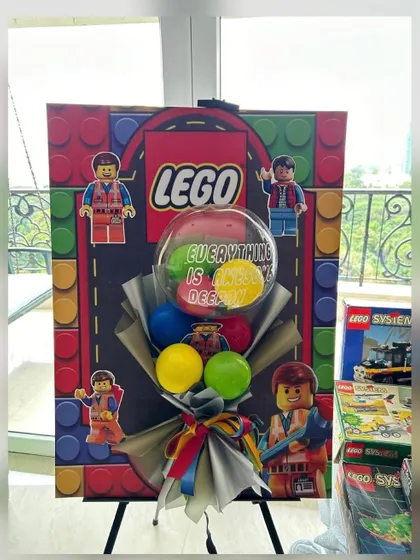 "Everything is awesome" with this Lego-themed 40th birthday setup. A custom-printed backdrop and a colorful balloon bouquet bring the fun and creativity of Lego to life for a playful milestone celebration.