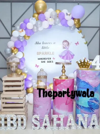 A grand Sofia the First theme for a 4th birthday, featuring a large backdrop and themed pedestals.
