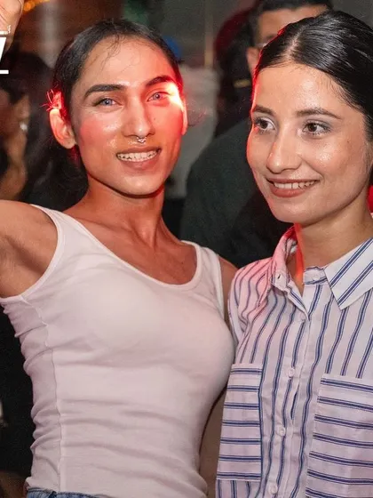 Two friends smiling for the camera, enjoying the inclusive atmosphere of my parties.