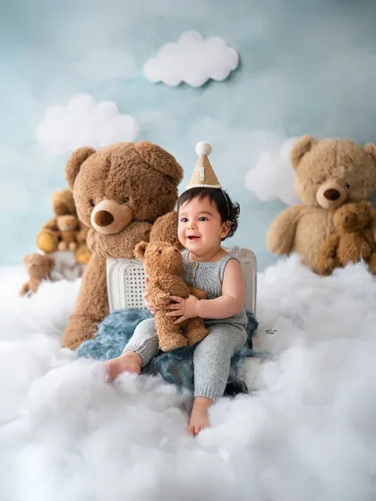 This little one is on cloud nine with his giant teddy bear. A dreamy and whimsical setup for a baby boy's photoshoot.