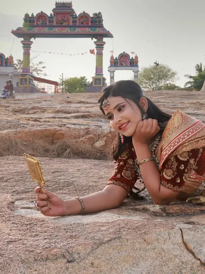 A closer portrait that captures a gentle expression. The temple arch in the background frames the shot and reinforces the traditional theme of the photoshoot.