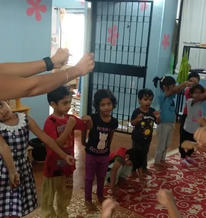 A dynamic and engaging yoga class in session. Movement and play are key to keeping young children engaged and learning.