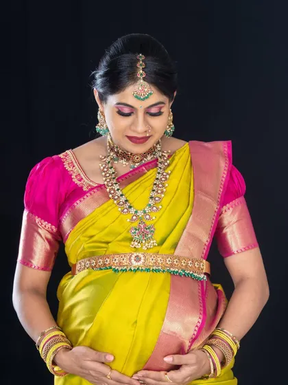 A portrait of the lovely mom-to-be, showcasing her pregnancy glow. The makeup is focused on shimmery eyes and a classic feel to match her traditional attire.