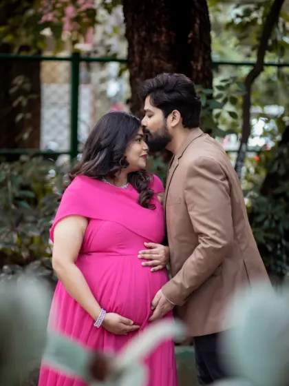 A sweet, protective embrace in a lovely garden setting. This photo captures the promise and excitement of the parenthood journey you are starting together.