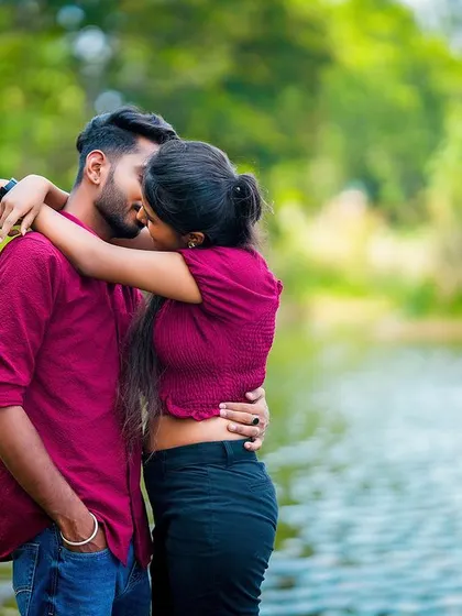 A passionate kiss shared by the couple in a beautiful outdoor setting, capturing the romance of their pre-wedding shoot.