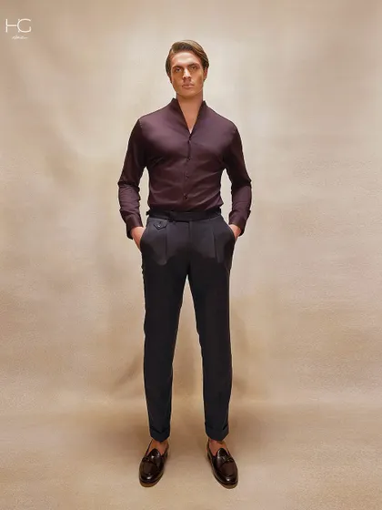 A full-length view of the burgundy shirt paired with dark tailored trousers. This combination creates a look of deep, understated luxury.