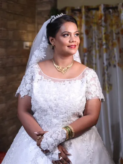 Simple, elegant glam for this beautiful bride. Her hair is styled in a classic updo, topped with a tiara and veil, and her makeup is soft and radiant.