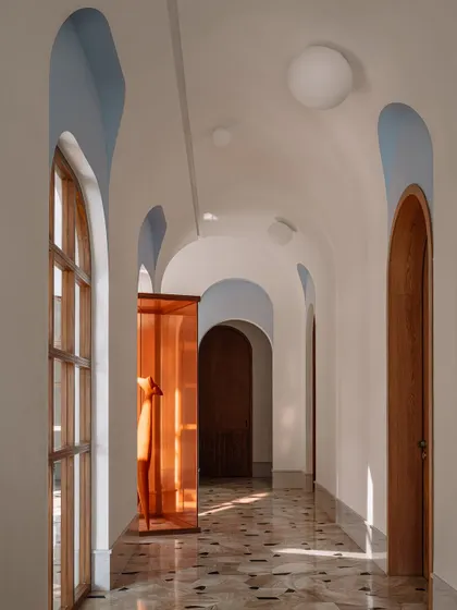 The L-shaped galleria at Rehethaan is defined by a series of arches with powder-blue finials and a vaulted ceiling studded with globe lights.