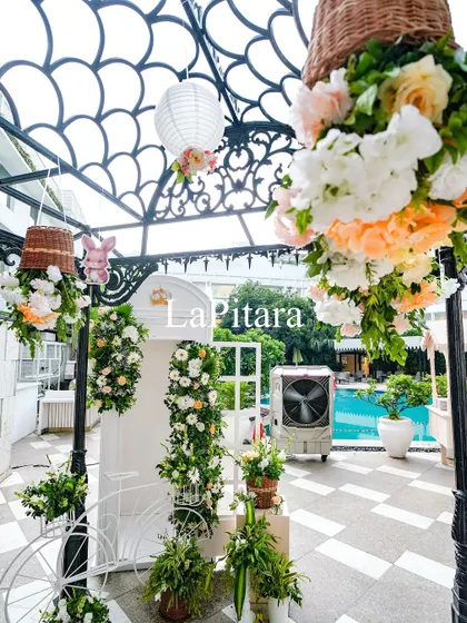 Another view of the poolside decor, showing the intricate trellis and hanging floral arrangements.