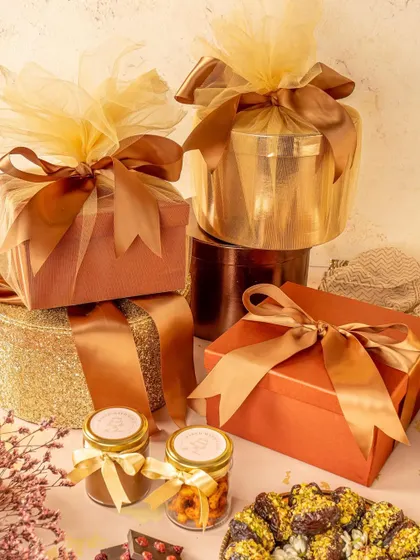 A stack of elegantly wrapped gift boxes. This shot is designed to showcase a brand's premium gifting options, focusing on the packaging and presentation.