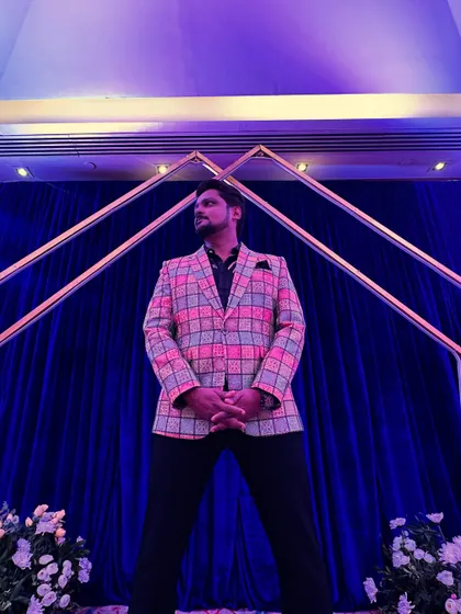 A powerful low-angle shot showcasing my stage-ready attire. A confident stance and a sharp outfit are part of my professional toolkit.