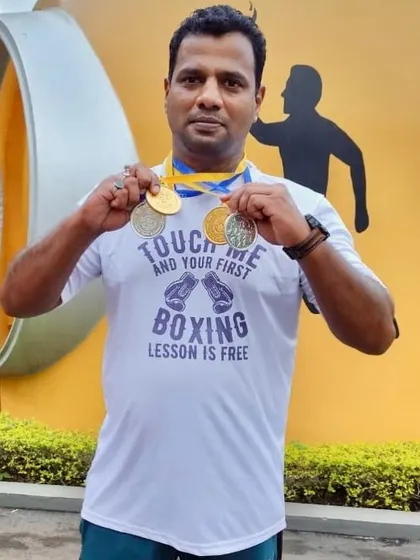 My victory pose with the medals won by my students. Their success is my success.