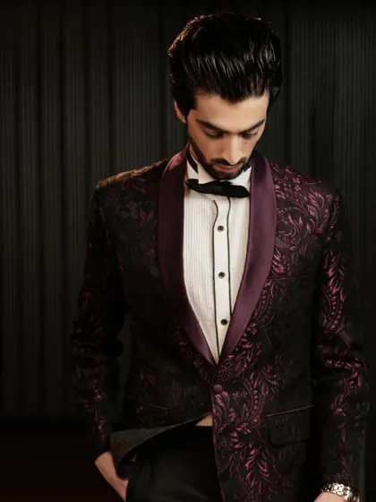 The deep, rich tones of the patterned tuxedo are perfect for evening events. It's a modern classic that exudes confidence and style.